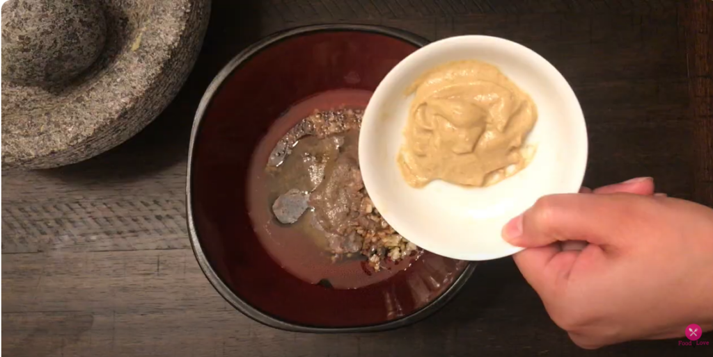 adding mustard to the bowl