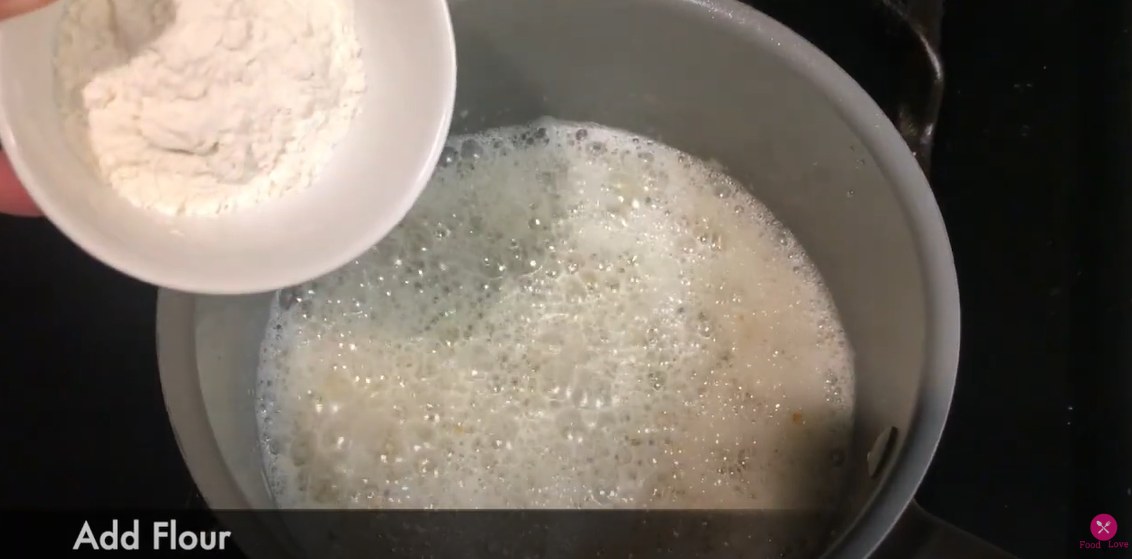 adding flour to the cooking mixture