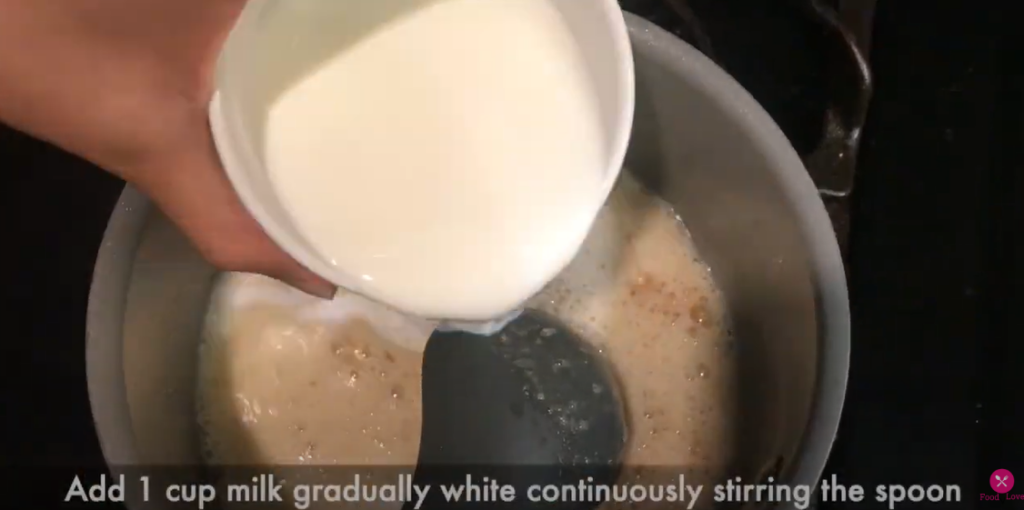 adding milk to the mixture in the pan