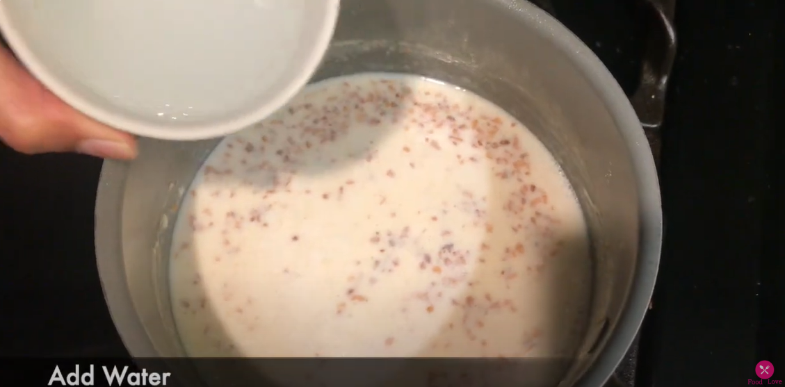 adding water in the pan that has white sauce mixture