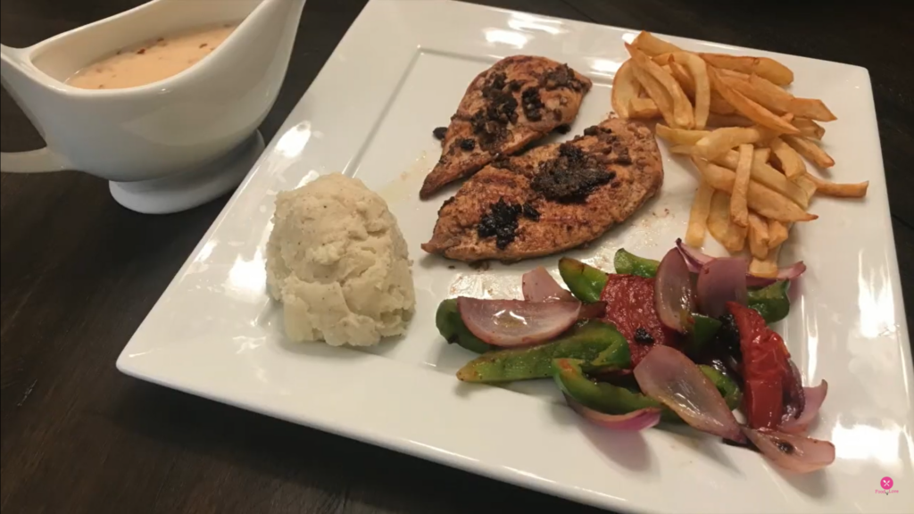 chicken steak with white sauce, mash potatoes, grilled veggies, and fries