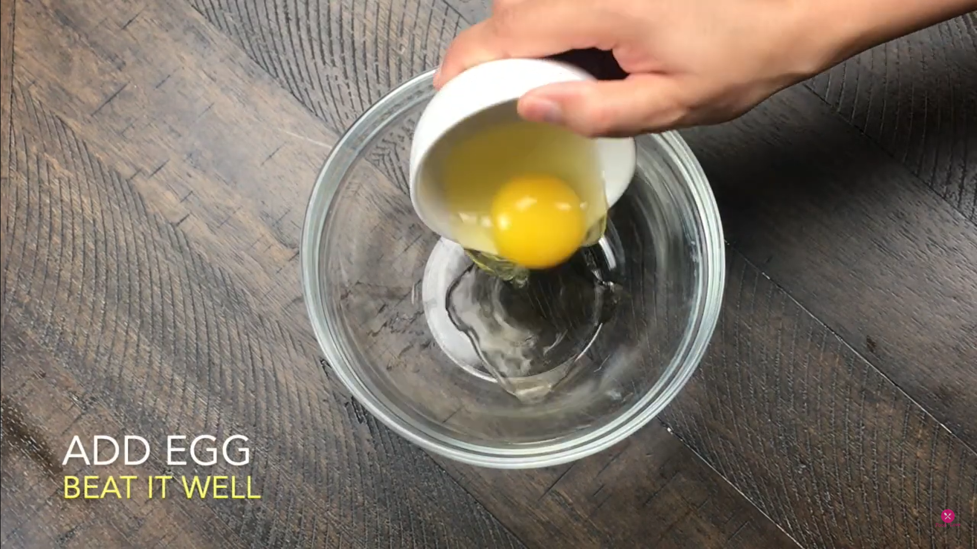 adding egg in a bowl