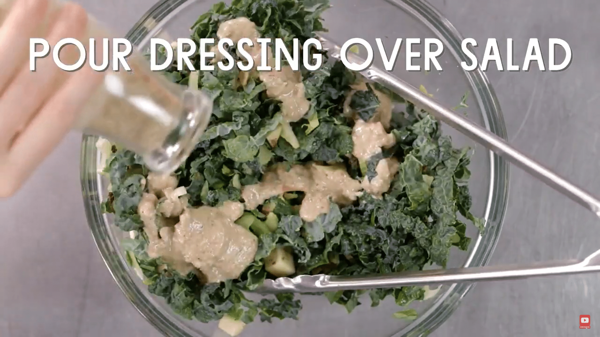 pouring dressing on the salad