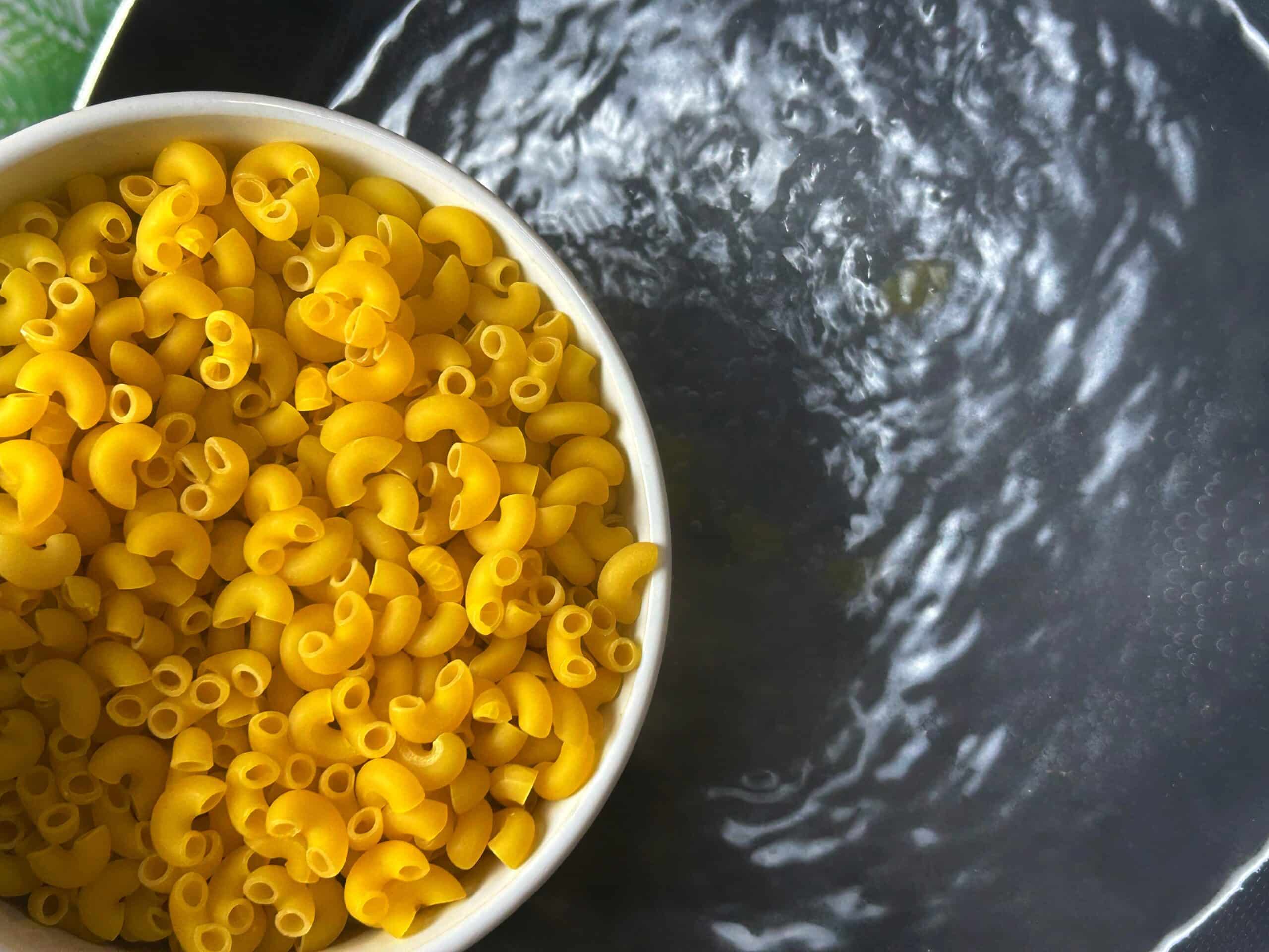 adding macaroni in boiling water