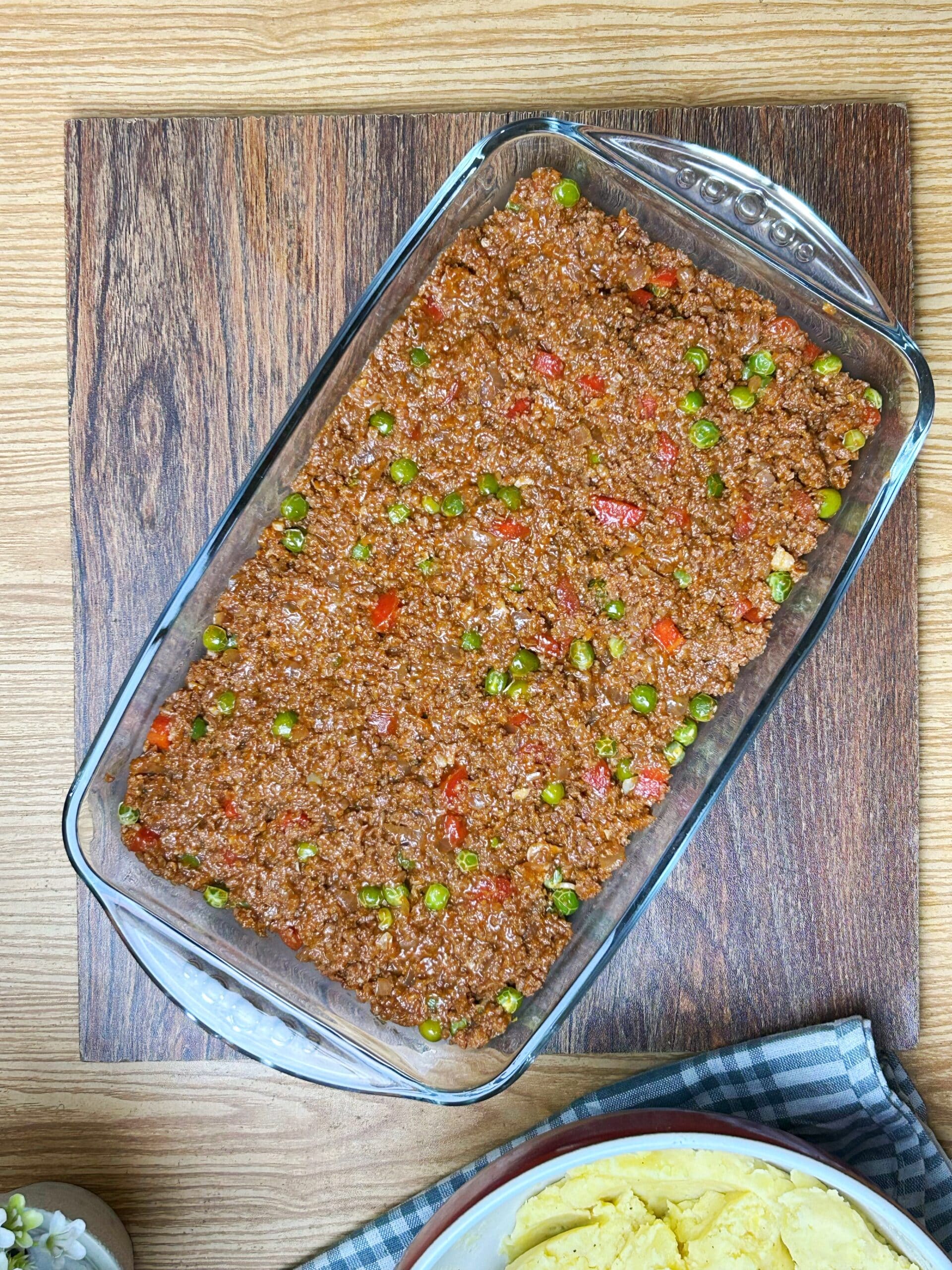 assembling the shepherd's pie recipe in a dish