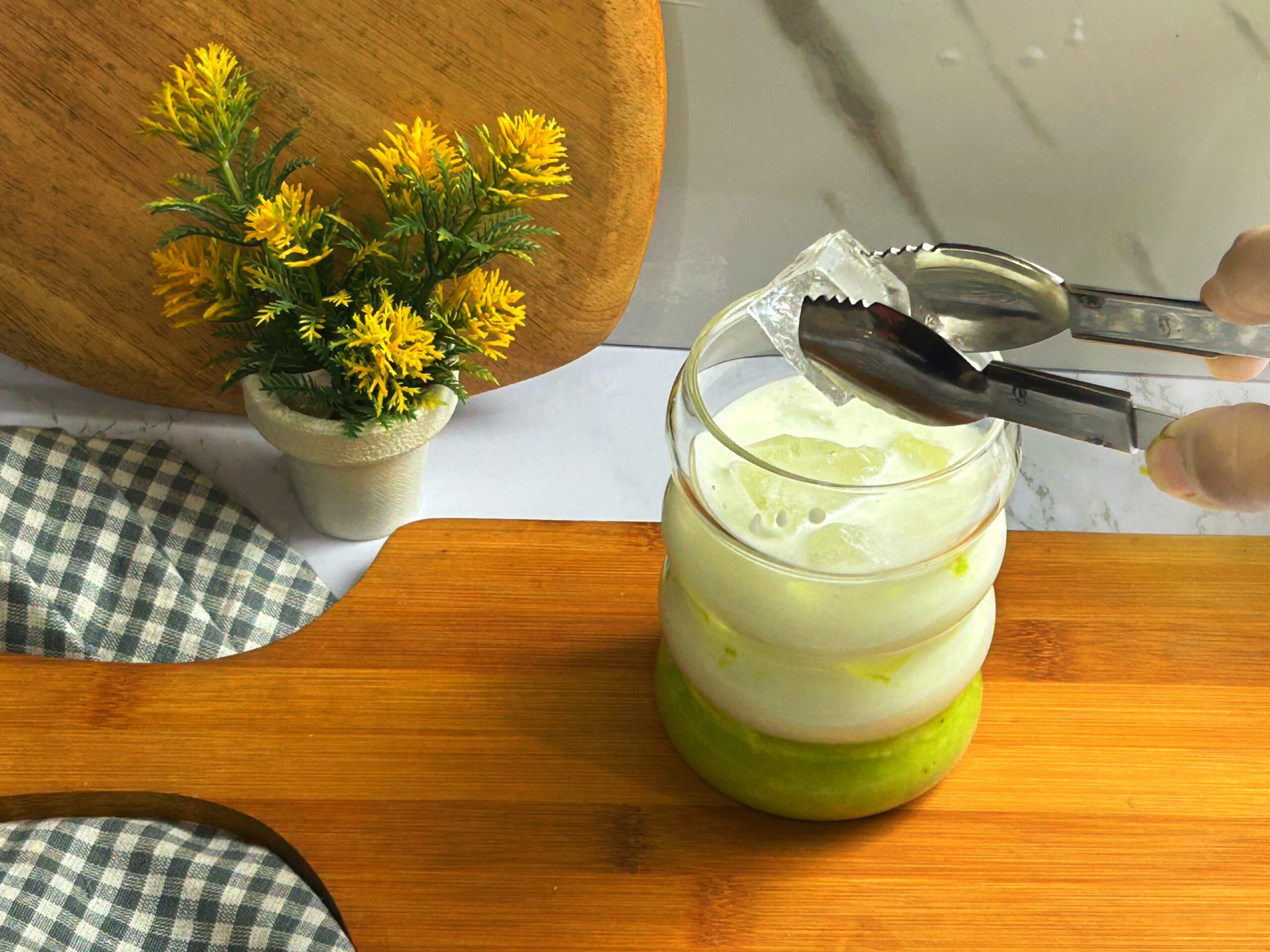 adding ice in the pistachio iced latte